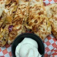 Chicken Quesadilla · Fresh Grilled Chicken, Onion, Shredded Cheese Blend, Z sauce,  with a side of Sour Cream.
