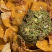 Loaded Nachos Plate · Spicy. Tortilla chips, vegan nacho cheese, refried beans, salsa and homemade guacamole.
