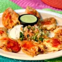 Chicken Nachos · (8) Crispy corn tortilla chips individually topped with a spread of refried beans, baked Chi...