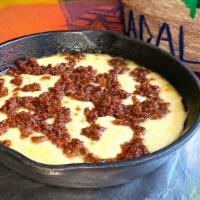 Queso Fundido · A delicious blend of baked Chihuahua cheese and chorizo (Mexican sausage). Served with warm ...