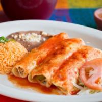 Enchiladas · Three rolled corn tortillas with choice of filling. Baked with Chihuahua cheese, and topped ...