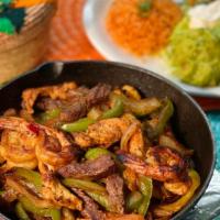 Combo Fajitas · Steak, chicken, and shrimp. Served with roasted onions, green peppers and tomatoes. With Spa...