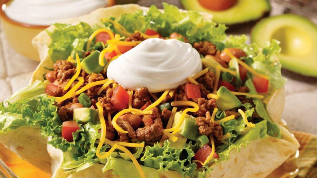 Vegetarian Taco Salad · Fried flour tortilla shell stuffed with lettuce at the bottom, rice, your choice of beans, sour cream, cheese, onions, cilantro, corn, guacamole and your choice of salsa.