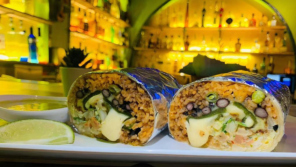 Maya Burrito · 12’’ Flour tortilla shell stuffed with rice, your choice of beans and roasted poblano pepper. Topped with lettuce, sour cream, corn and your choice of salsa.