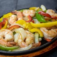 Fajitas De Camaron · Onions, green and red peppers cook with shrimps. Served with rice, beans and tortillas on th...