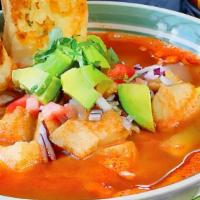 Sopa De Mariscos · Tilapia, octopus, shrimp, carrots, celery, and potatoes in chipotle broth. Served with toast...