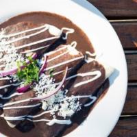 Enfrijoladas · Four rolled corn tortillas topped with blended home-made pinto beans, queso fresco, and avoc...