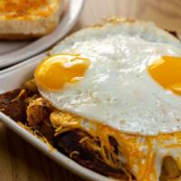 The Golden Skillet · Grilled corned beef hash, served over hash browns, and smothered with our country sausage gr...