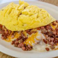Made In Oklahoma · toasted biscuit topped with hash browns sausage gravy cheddar sausage ham bacon and two eggs...