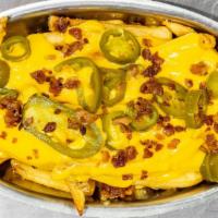 Voodoo Fries · Supersized Fries with Jalapeño, Bacon and Aged Cheddar Cheese sauce!