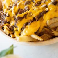Philly Loaded Fries · French Fries, 8oz Shaved Rib Eye Steak, Sautee Onion Mushroom, American Swiss topped with Ch...
