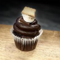 S'Mores Cupcake · Chocolate Cupcake, Filled with marshmallow fluff, topped with Buttercream, Graham cracker cr...