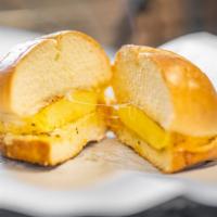 Egg Breakfast Sandwich · Seasoned Egg, Italian Seasoning, Mozzarella and Cheddar Cheese Blend on a brioche Bun with o...
