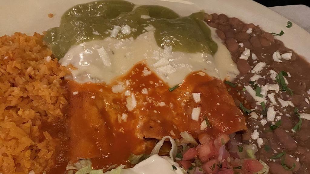 Trio Enchiladas · One beef, one chicken and one cheese with red, green and cheese sauce on top.
