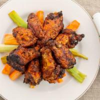 Grilled Chicken Wings · Char-grilled wings seasoned & tossed in Jones’ own buffalo wing sauce. Served with blue chee...