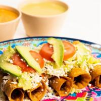 Tacos Dorados · 4 corn tortillas stuffed with chicken or cheese, topped with lettuce, cheese, sour cream, to...
