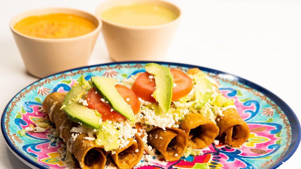 Tacos Dorados · 4 corn tortillas stuffed with chicken or cheese, topped with lettuce, cheese, sour cream, tomato and avocado.