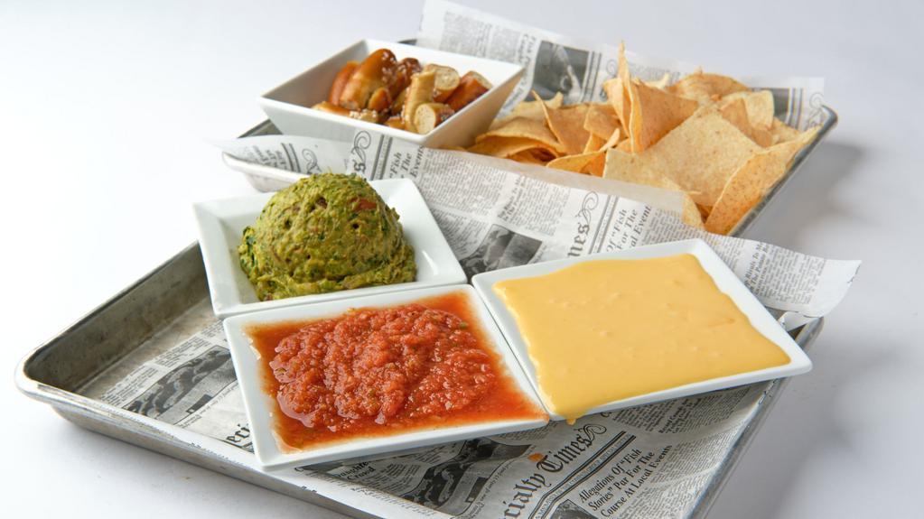 Den Trio · Tortilla chips & Pretzel bites, served with Blue Moon beer cheese, guacamole & salsa.