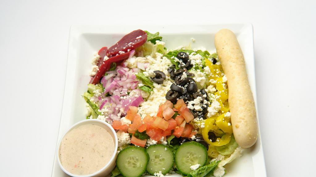Greek · Mixed greens, feta cheese, banana peppers, beets, black olives, tomatoes, cucumbers, red onions, served with Greek dressing.