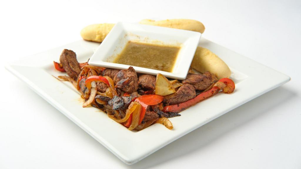 Tenderloin Steak Bites · 8 oz of tenderloin with grilled mushrooms, Onion, Red peppers served with zip sauce and two garlic bread sticks on side.