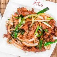 Mongolian Beef · Tender slices of marinated beef and green onions bedded on crispy white bean noodles.