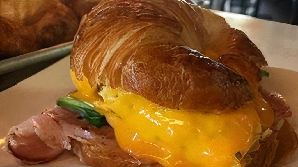 Breakfast Croissant · Choice of bacon, ham, or spinach. // Bagel or croissant sandwich topped with scrambled eggs and melted cheddar cheese. Served with rosemary breakfast potatoes