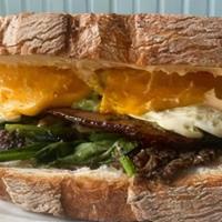 Ultimate Breakfast Sandwich · Choice of Bacon, Ham, or spinach. // Toasted sourdough with two fried eggs, cheddar cheese, ...