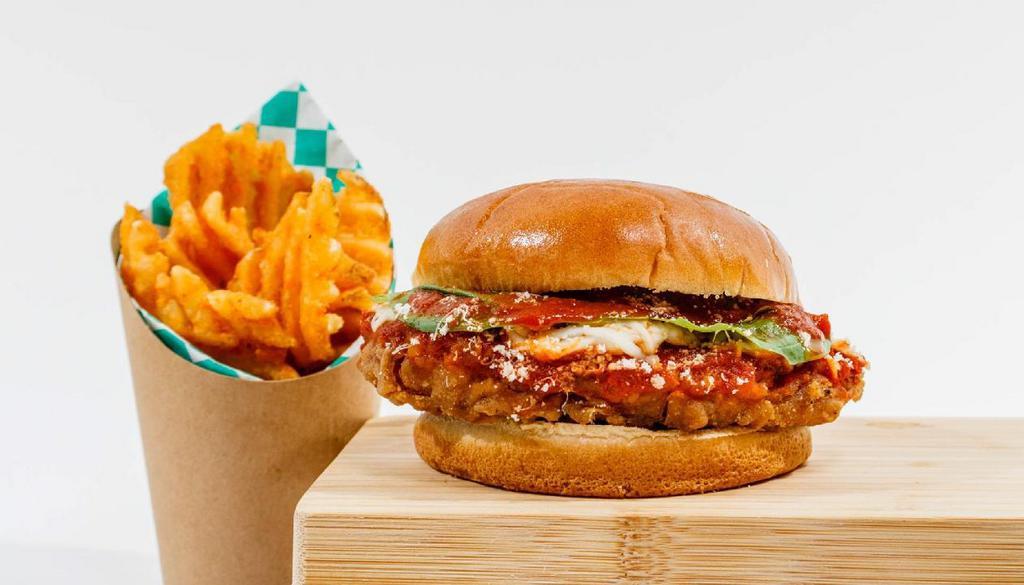 Chick’N Parm Sandwich · Golden brown plant-based southern fried Chick’n breast with marinara sauce, melted mozzarella, provolone and parmesan cheeses. Topped with oregano and fresh basil on a potato bun. You’re welcome.