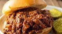 Bbq Pork And Brisket Sandwich · Smoked and chopped beef brisket and pulled pork with coleslaw and bbq sauce on a fluffy bun.