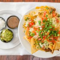 Nachos · fresh tortilla chips, seasoned beef, mexican cheese blend, pico de gallo and shredded lettuc...