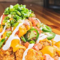 Muchaco Totchos · A Golden Tower of Tater Tots covered in Cheese, Scallions, Sour Cream, Pico de Gallo and Jal...