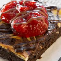 Cherry Cheesecake Brownie · Our homemade cheesecake swirled brownie topped with yummy cherries, and drizzled in chocolat...