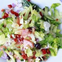 Greek Salad · Fresh romaine greens, onions, olives, red peppers, and feta cheese served with our signature...