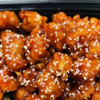 Sesame Chicken · Served with egg roll and fried rice.