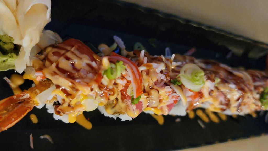 Fuji · (Shrimp tempura, Cucumber inside). Salmon, Tuna, Yellowtail, Crab Salad, Masago, Scallion, Eel sauce, and Spicy mayo.