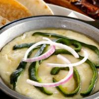 Queso Fundido · Melted Mexican cheese with choice of topping.