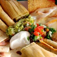 Botana Combinada · A delicious appetizer combination consisting of nachos, ham quesadillas, tamales, and flauta...
