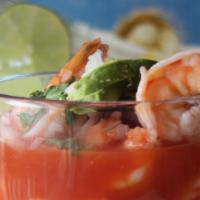 Coctel De Camaron · A delicious shrimp cocktail garnished with onions, cilantro, diced tomatoes and slices of fr...
