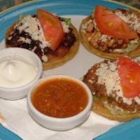 Sopes · Three ground beef, steak, chicken, shredded beef or seasoned pork sopes topped with beans, l...