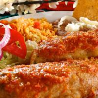 Chiles Rellenos De Queso · Two poblano peppers filled with cheese, egg-battered and pan-fried in our mild ranchera sauc...