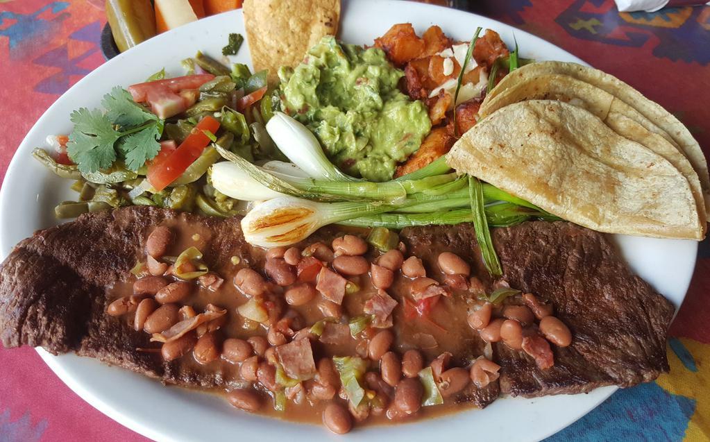 Carne Asada Zamora · Skirt steak cooked to your taste and topped with our original frijoles charros. Served with two quesadillas, cactus salad, green onions, Mexican potatoes, guacamole, refried beans and Spanish rice.