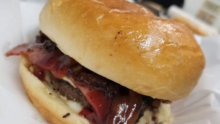 Bbq Burger · Hamburger, Sweet Baby Ray's BBQ sauce, smoked turkey bacon, Onion Rings, swiss cheese, and mayo.
