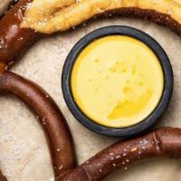 Pretzel · Jumbo pretzel baked in-house.  Served with spicy cheese sauce.
