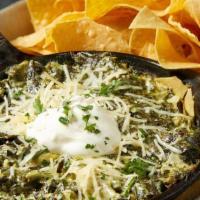Spinach & Artichoke Dip · Chopped spinach and artichokes simmered in a parmesan cream sauce.  Served with chips and sa...