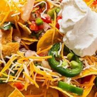 Nachos · Choice of beef, chicken or pork atop fresh tortilla chips piled high with spicy cheese sauce...