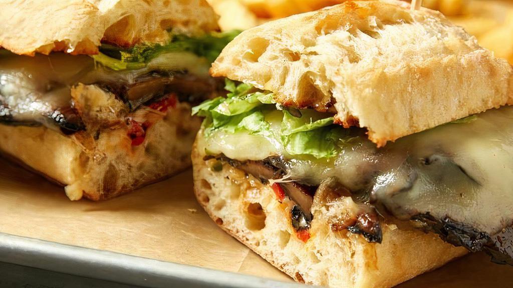 Portabella Mushroom Stack · Two grilled portabella mushroom, marinated in house-made vinaigrette, with roasted red peppers, Monterey Jack cheese and roasted red pepper aioli served on a ciabatta roll.