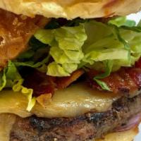 Smoky Burger · 8 oz. Angus beef burger, applewood smoked bacon, smoked mozzarella, chili sauce, lettuce, ga...