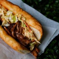 Bbq Pulled Pork Sandwich · Zesty BBQ sauce, toasted garlic, chili flakes, and spicy slaw.