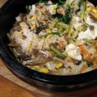 Bibimbop · A bed of rice topped with assorted delicate Asian vegetables with Beef and fried egg on top.