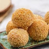 Sesame Balls (10) · Sesame balls are cripsy on the outside and soft and sweet inside. They're filled with red be...